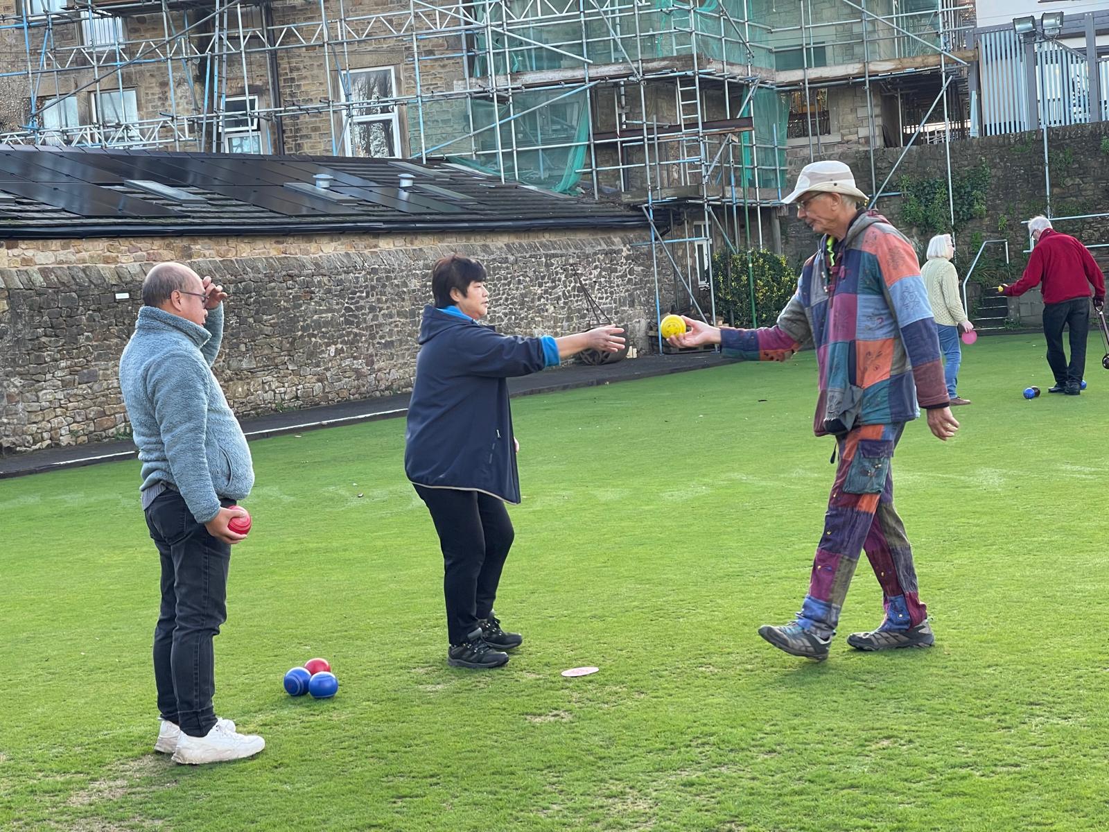 Members bowling together on the green